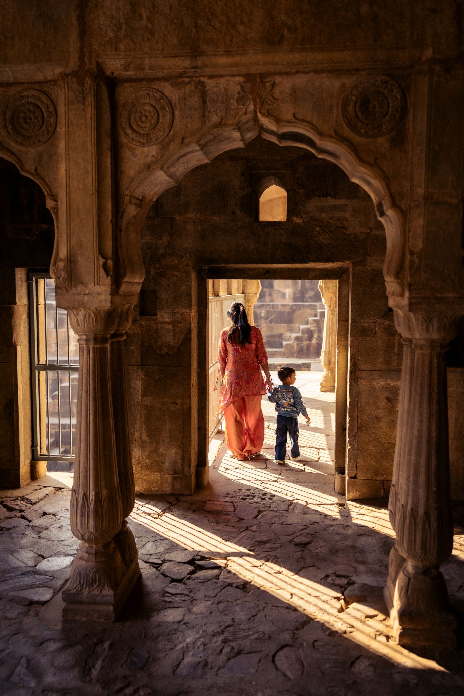 Woman And Child Framed In Arched Interior